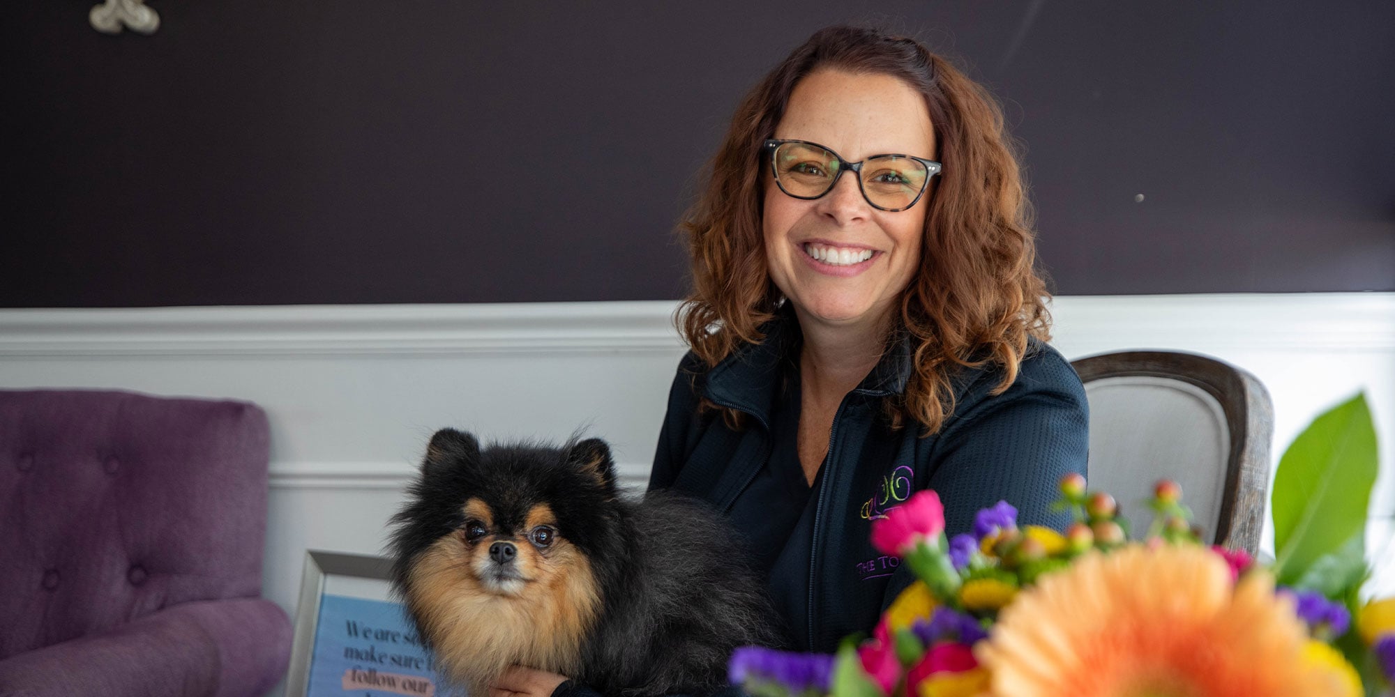 Invisalign patient smiling with the dental canine companion