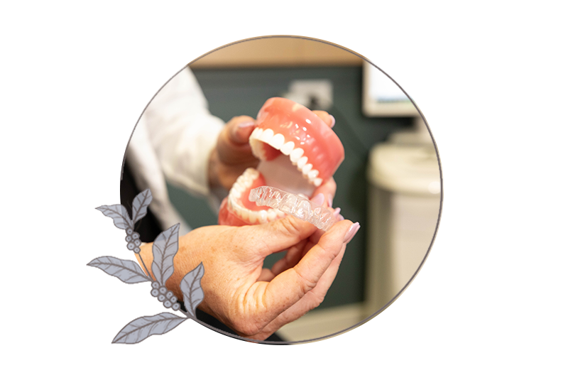 close up of doctor demonstrating Invisalign patient on hoe Invisalign works