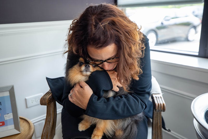 patient hugging tightly The Toothery canine companion