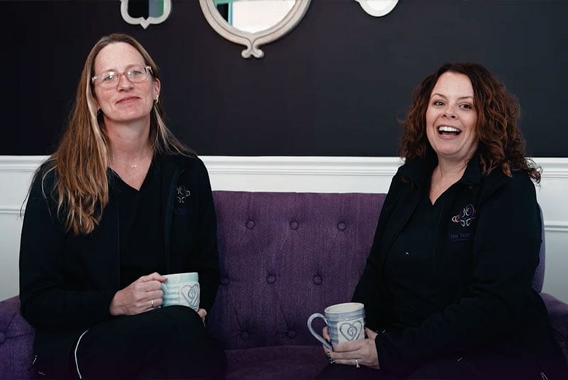 Staff members sitting down in the lobby of the dental practice